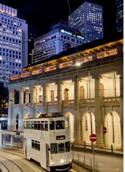 Mandarin Oriental 60th Anniversary tram at evening in Central, Hong Kong with Mandarin Oriental Hotel in background